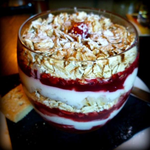 Cranachan: Whiskey, cream, raspberries and toasted oatmeal are layered in a tall glass. 